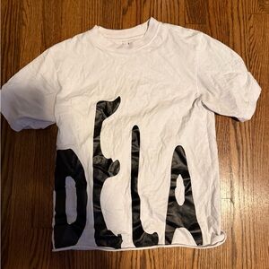 White Crew Neck Tee with Distressed Black DELA Print